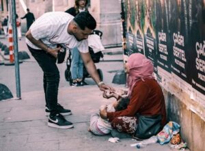 muslim man giving charity or sadaqah during ramadan