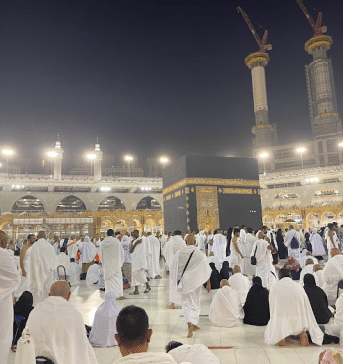muslims doing tawaf around the kaaba and touching the black stone