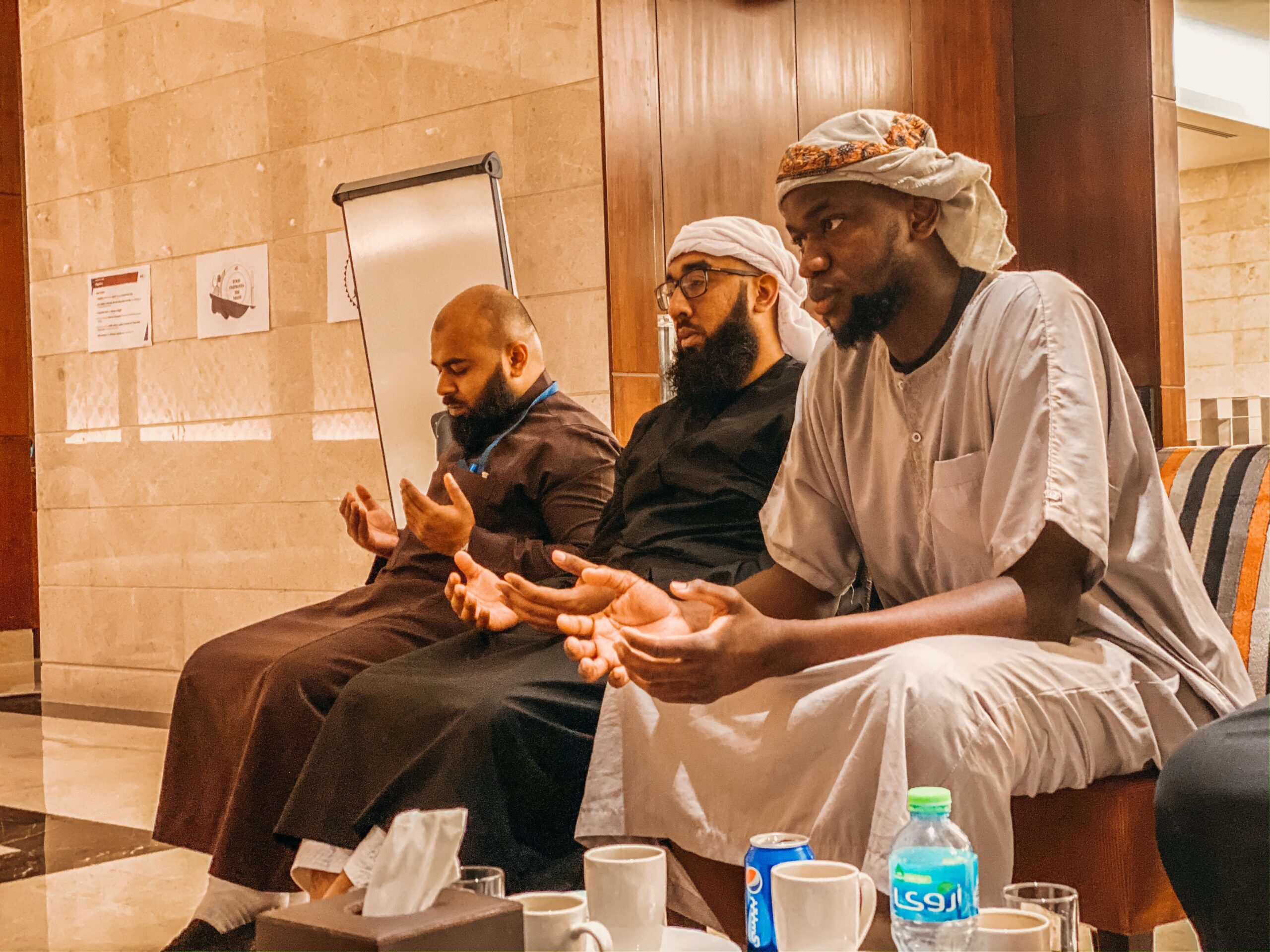 vaccinated muslim men praying together
