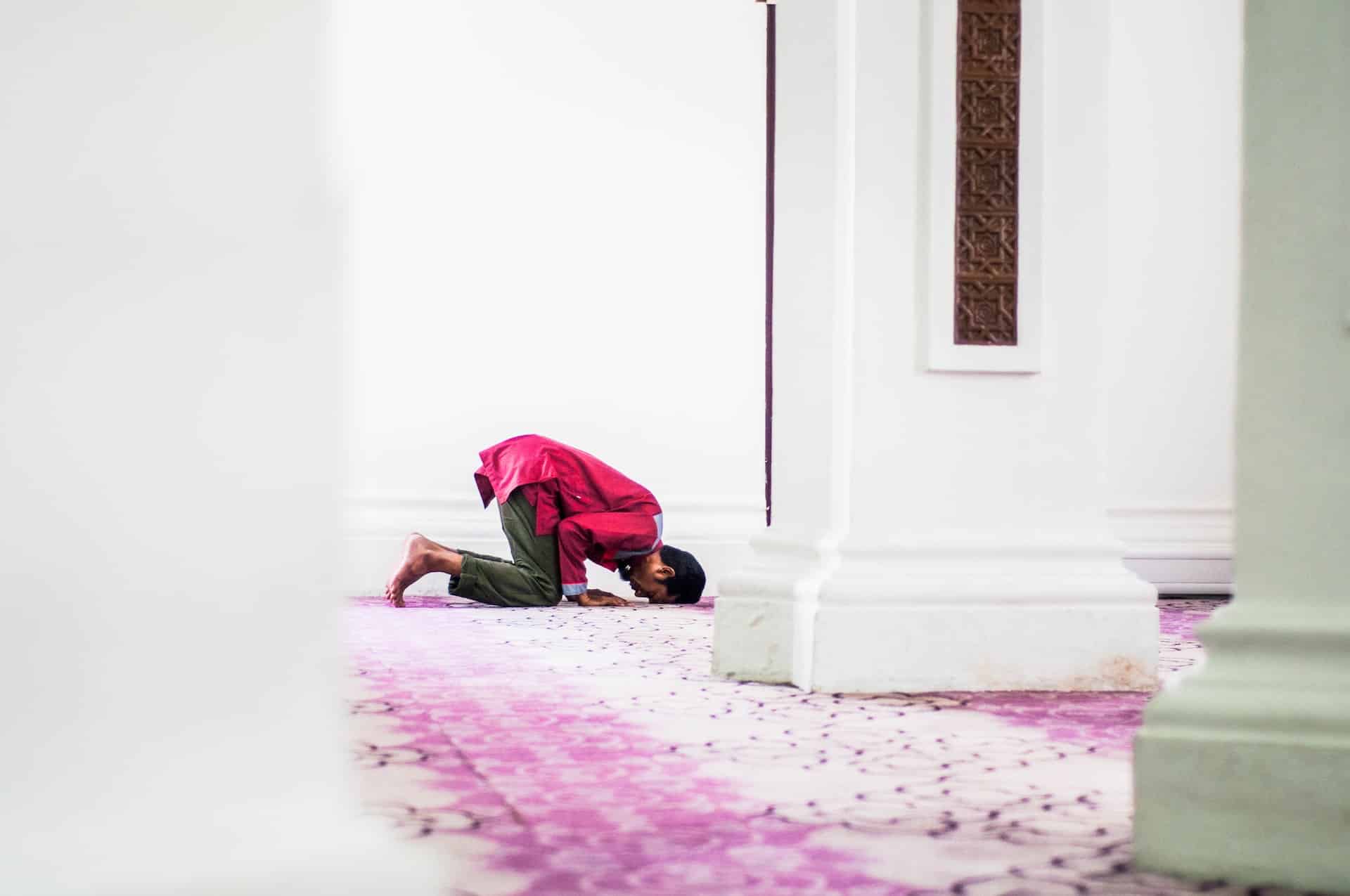 muslim man praying in mosque to perform hajj or umrah