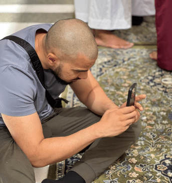 muslim on his phone during the adhan